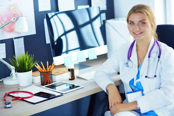 Όμορφη Νεαρή Χαμογελαστή Γυναίκα Γιατρός Κάθεται Στο Γραφείο — Φωτογραφία Αρχείου