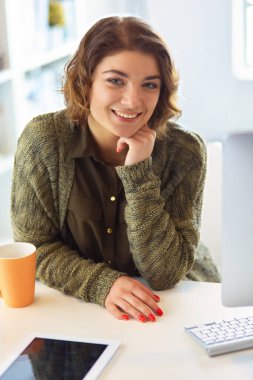 Öğrenci laptopla çalışıyor ve evdeki masada oturuyor..