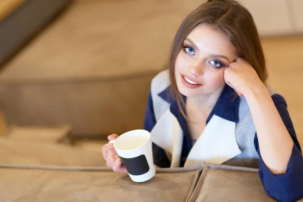 Young Woman Sitting Comfortable Sofa Cup Coffee Hands White Room — Stock Photo, Image