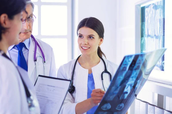 stock image Smiling doctors discussing patients diagnosis looking at x-rays in a hospital