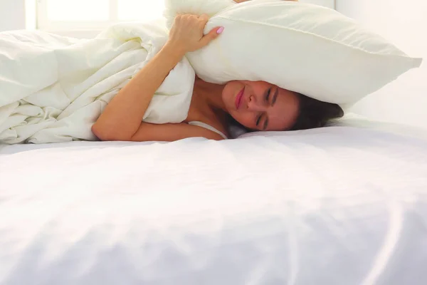 Young Caucasian Woman Covering Her Head Ears Pillows — Stock Photo, Image
