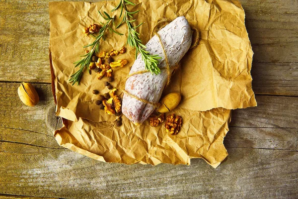 Italian Salami Wih Sea Salt Rosemary Garlic Nuts Paper Rustic — Stock Photo, Image