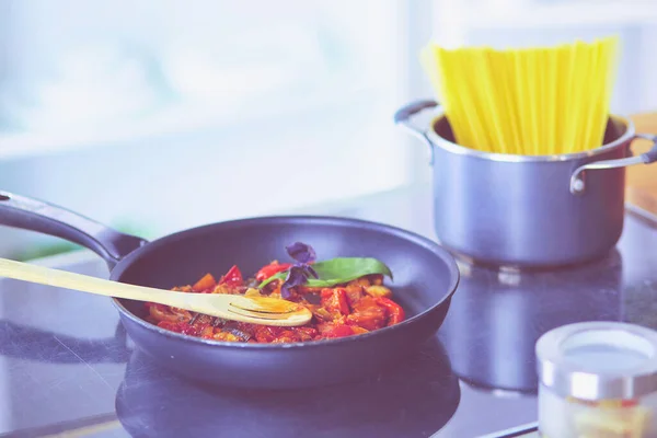 stock image Young woman in the kitchen preparing a food.