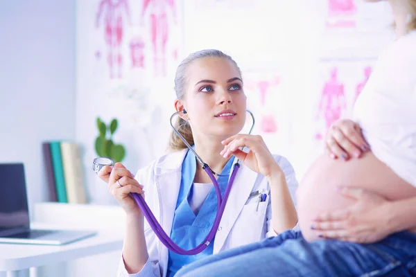 stock image Young woman doctor with stethoscope speaking with pregnant woman at hospital