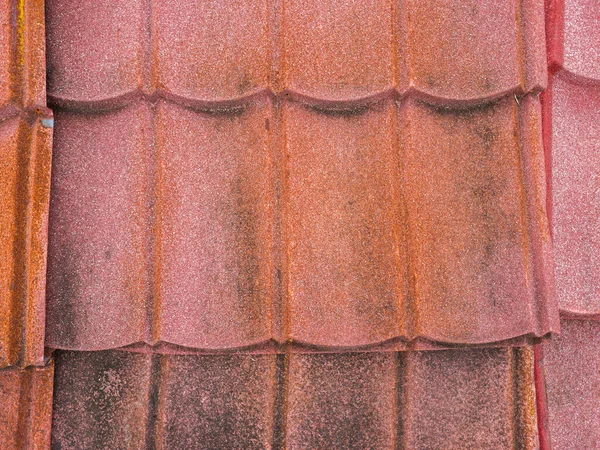 roof covered with red tiles, old and ruined roofs. Texture of a roof with old roof tiles.