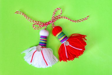 Bulgarian symbol of spring white and red martenitsa on green background