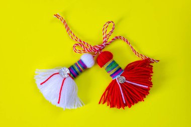 Bulgarian symbol of spring white and red martenitsa on yellow background