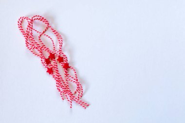 Bulgarian symbols of spring, many white and red martenitsa on white background