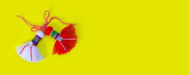 Bulgarian symbol of spring white and red martenitsa on yellow banner background