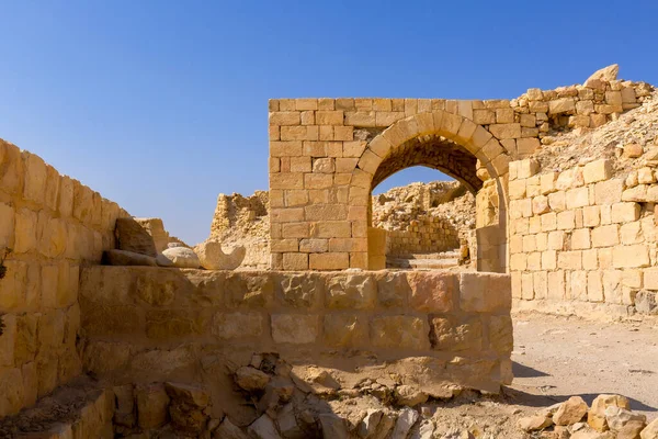 Arch and ruins of crusaders Shobak Castle in Jordan against blue sky