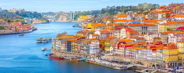 Porto, Portugal old town ribeira aerial promenade view with colorful houses, Douro river and boats