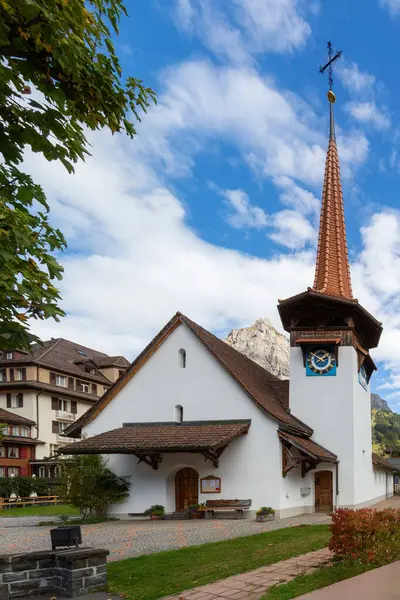 stock image Kandersteg, Switzerland street view with church and bell tower and mountains panorama, Canton Bern, Europe