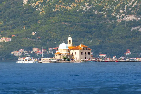 stock image Perast, Montenegro - September 21, 2023: Tourist boat in Bay of Kotor. Island of Our Lady of The Rocks or Gospa od Skrpjela and people