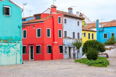 Burano Adası, İtalya - 1 Ekim 2024 Venedik yakınlarındaki ünlü adada renkli evler mimari ve sokak. Seyahat ve tatil kavramı