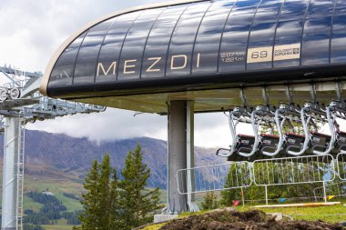 Ortisei, Italy- September 26, 2024: Summer Empty Leitner chairlift of ropeway, many cabins waiting for the season at the station, Dolomites Alpe di Siusi, in summer clipart