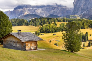 Dolomites Alpe di Siusi, Italy beautiful scenery, natural autumn landscape with house, mountains and meadows clipart