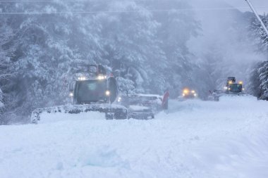 Bansko, Bulgaria snow groomer snowcat, row of ratracks machine preparing ski slope for alpine skiing, winter resort clipart