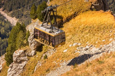 Ortisei, Italy - September 29, 2024: Cable car to Seceda in Val Gardena, Dolomites Alps in autumn clipart