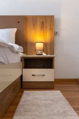 Yatak odası lambası bir gece durağında, yatağın yanında, yakın plan.