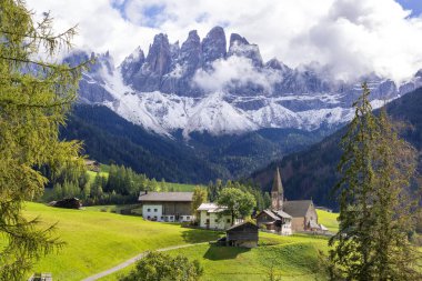 Dolomitler, İtalya. St. Magdalena ya da Santa Maddalena kilisesi, Geisler Odle dağları ve yeşil dağların geniş panoramik manzarası.