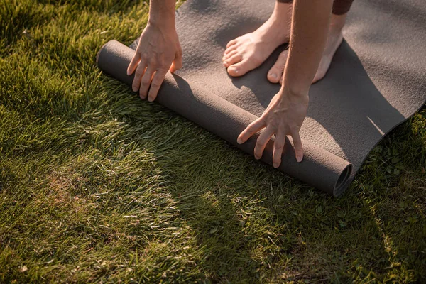 Yoga girl with yoga mat in summer or autumn park