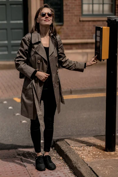 stock image Portrait of a beautiful  woman walking in  the street wearing beige raincoat. Autumn atmosphere