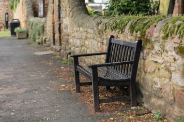 Beautiful scene. Lonely bench in the old medieval village  clipart