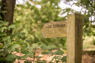 A wooden sign showing the way of the England Path taken in the UK clipart