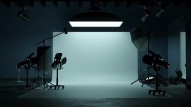 A large blank photo studio background with various lighting equipment. 