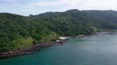 Aerial footage of Koh Phi Phi Don Western Ton Sai bay cliffs overlooking crystal clear turquoise color bay near monkey beach.