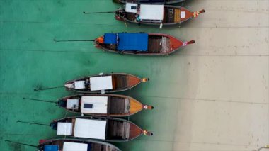 Rawai sahilindeki tropikal denizde uzun kuyruklu balıkçı tekneleri. Phuket Tayland. Güzel deniz yüzeyi. İnsansız hava aracı kamerasından yüksek kaliteli video..