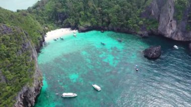 Aerial footage from a drone of Nui Beach, Thailand with clear blue water.