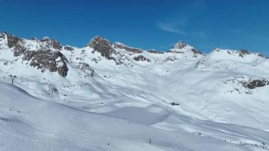 Flight over a snowy mountains in winter - wonderful Swiss Alps - aerial photography.