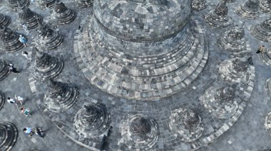 Borobudur 'teki en büyük stupa' nın etrafında taştan stupalar var. Büyük stupanın etrafındaki karmaşık detaylar yukarıdan güzelce yansıtılıyor, antik zanaatkarlığı ve geometrik uyumu gözler önüne seriyor..