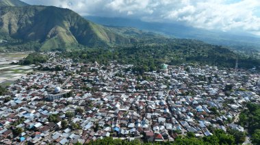 The village of Sembalun nestles at the foot of rolling hills, its rooftops blending into the lush scenery an authentic glimpse of rural life in Lombok.