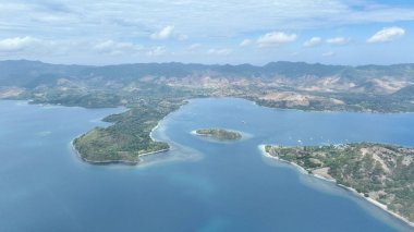 Yukarıdan gelen Gili Goleng, dokunulmamış yeşil tepelerin turkuaz sularla buluştuğunu gösteriyor. Macera ve sükunet arayanlar için mükemmel bir gizli mücevher. Bu tropikal cennette huzuru keşfet..