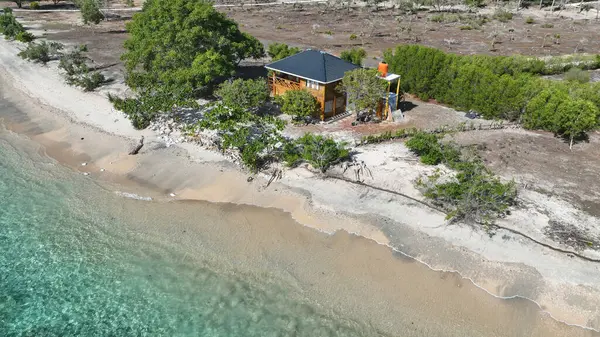 Yeşillik ve turkuaz denizden sadece birkaç adım uzaklıktaki havadan kumsala bakan bir kulübe. Ada Gede 'nin bu gizli tropikal inzivada huzurlu atmosferini hissedin..