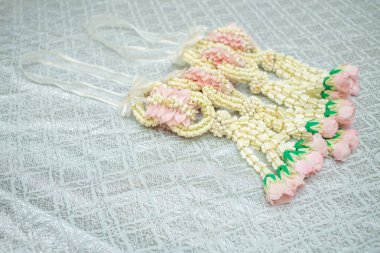 Tayland usulü güzel yasemin çelengi. Gümüş bir arka planda. Tayland desenli..