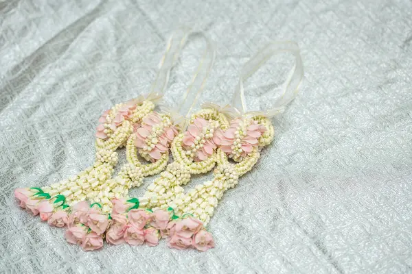 Tayland usulü güzel yasemin çelengi. Gümüş bir arka planda. Tayland desenli..