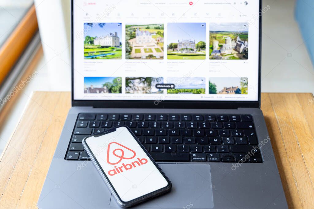 Paris,  France - November 30, 2023 :smartphone with Airbnb application. Airbnb is an online marketplace and hospitality service, enabling people to lease or rent short-term lodging