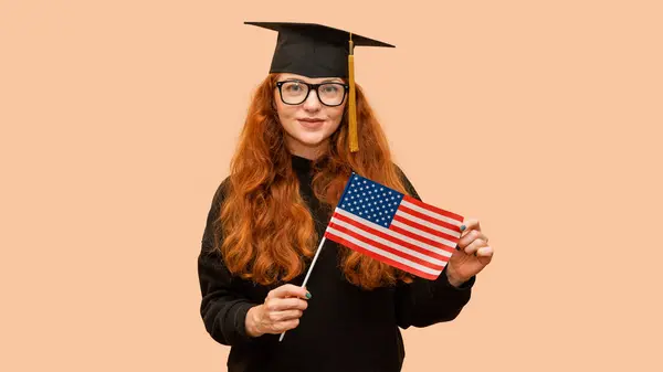 Young Female Graduate Student Usa Flag Wearing Bachelor Cap While Royaltyfria Stockfoton