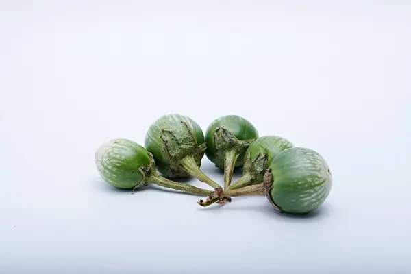 Sağlıklı yeşil yuvarlak patlıcan. Beyaz tabanlı ve arka planda çekilmiş sebze.