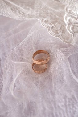 Gold wedding rings with bride's veil