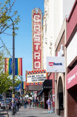 Haight Ashbury Caddesi, San Francisco, Kaliforniya, ABD - 23 Nisan 2023: Güneşli ve bulutsuz mavi gökyüzünde şehir binalarına karşı renkli kaldırımlarda yürüyen yayalar ile dolu cadde