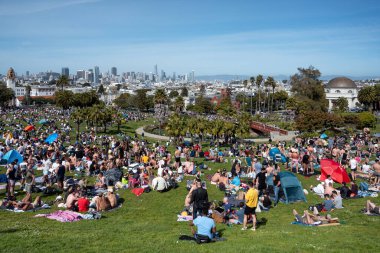 San Francisco, California - 25 Nisan 2023: İnsanlar mavi gökyüzüne karşı ilkbahar boyunca Dolores Park Misyonunda boş vakitlerin tadını çıkarıyorlar
