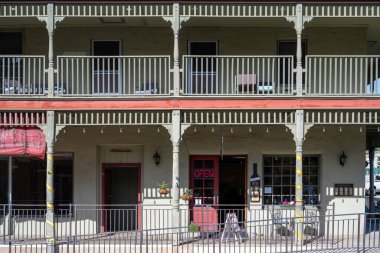 Mariposa, ABD - 04, 28, 2023: Güneşli bir günde sütunları ve balkonları şarap restoranı ve oteli olan tarihi bina