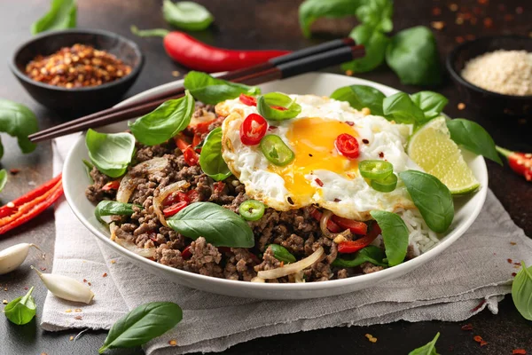 Stock image Stir Fried Pad Kra Pao with rice and egg in white plate.