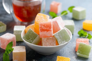 Sweets turkish delights with glass of tea. clipart