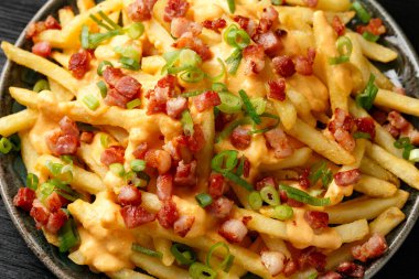 Crispy French fries loaded with bacon, cheese sauce and spring onion.