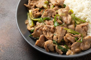 Chinese stir fry pork with ginger sauce, garlic and spring onion. Asian food.